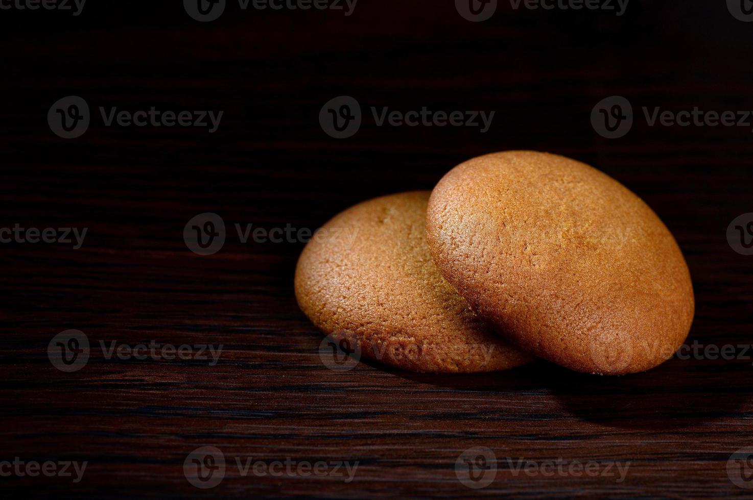 Biscuits filled with chocolate cream. Chocolate cream cookies. brown chocolate biscuits with cream filling on black background. photo