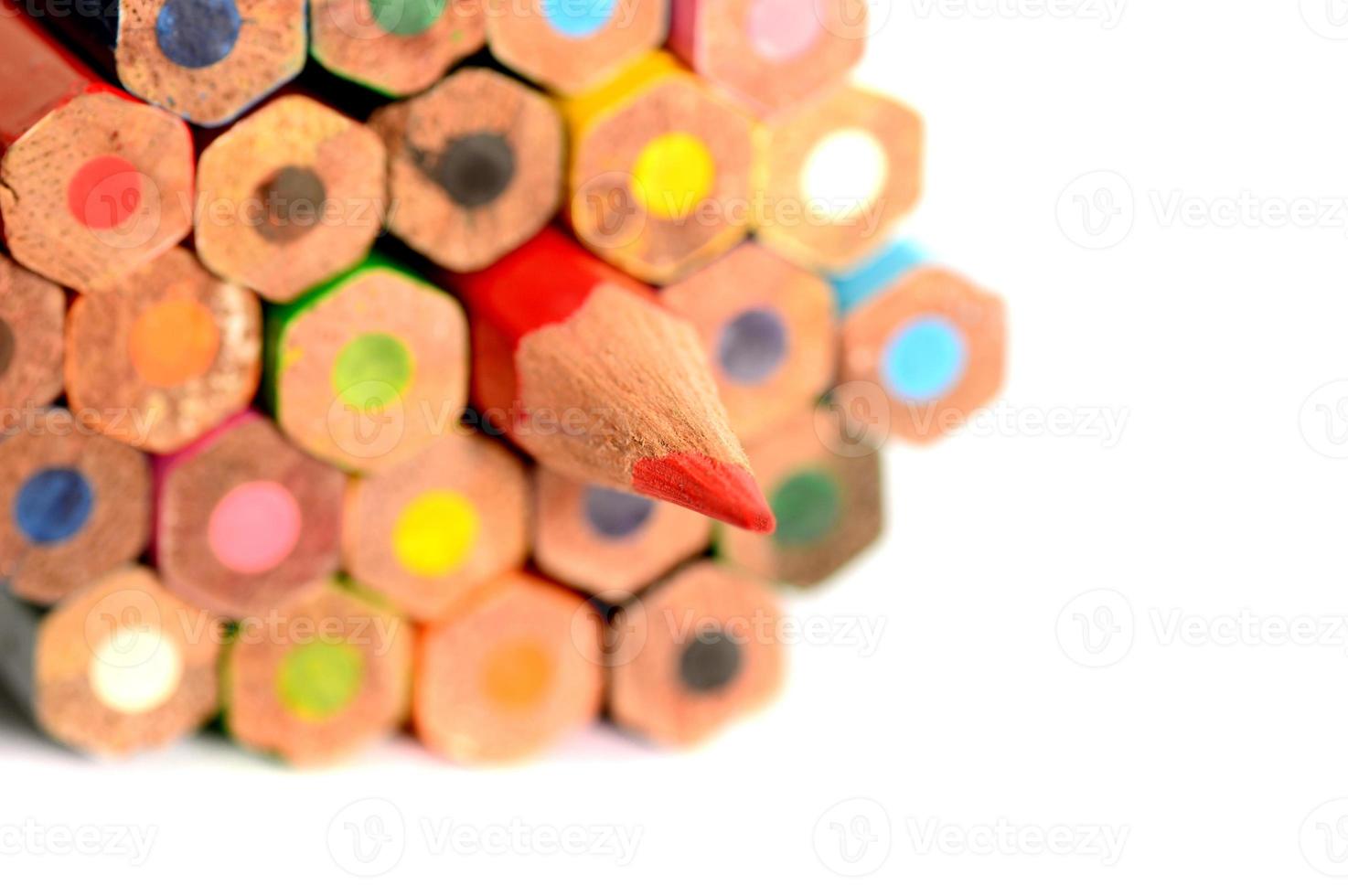 Colour pencils isolated on white background close up photo