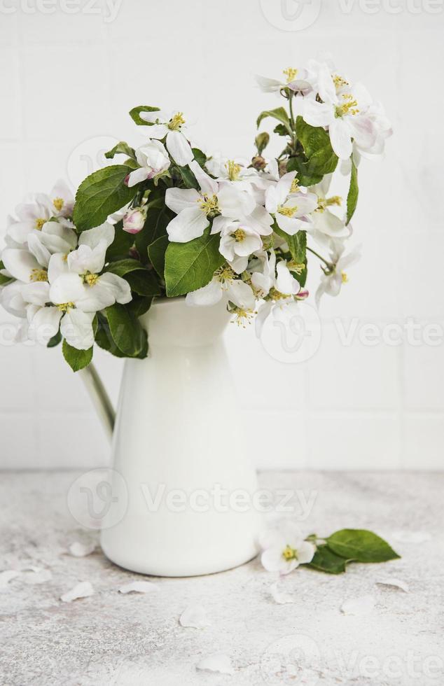 Spring apple blossom in a white vase photo