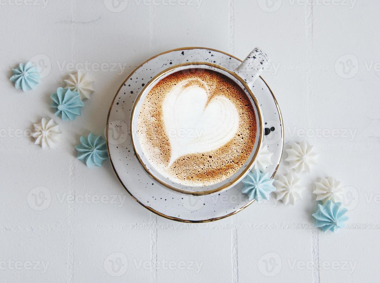 Cup with coffee and small meringues photo