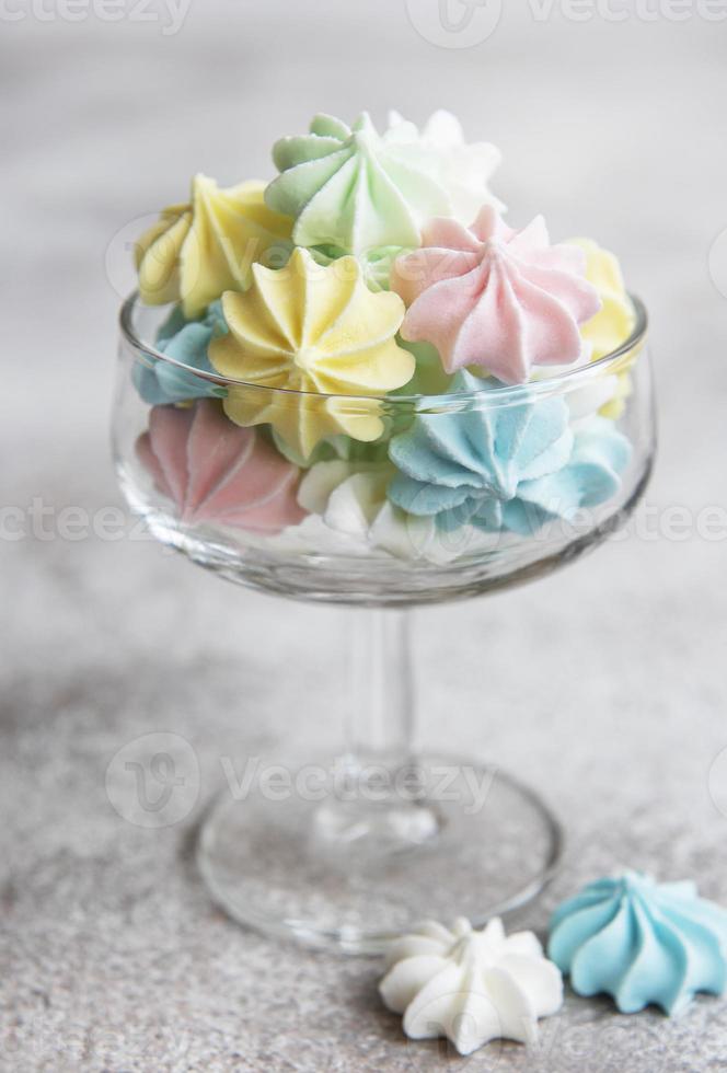 Small colorful meringues in the glass photo