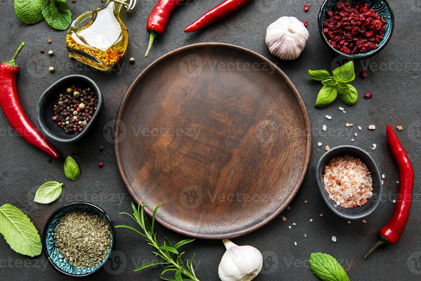 Empty wooden plate and frame of spices photo