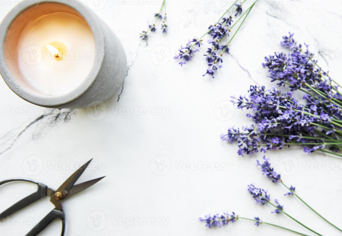 flores de lavanda, vela y tijeras foto