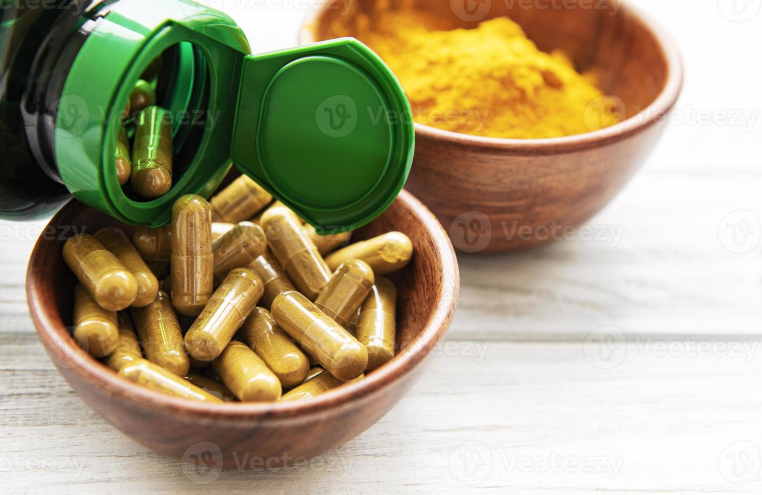 Turmeric powder and capsules photo