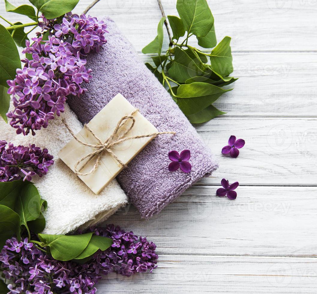 Spa towels and soap and lolac flowers photo