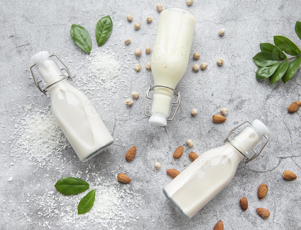 Alternative types of vegan milks in glass bottles photo