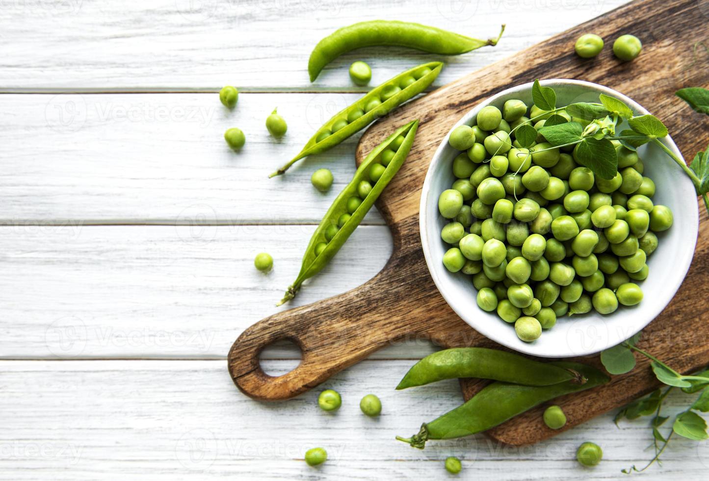 Green peas in white bowls photo