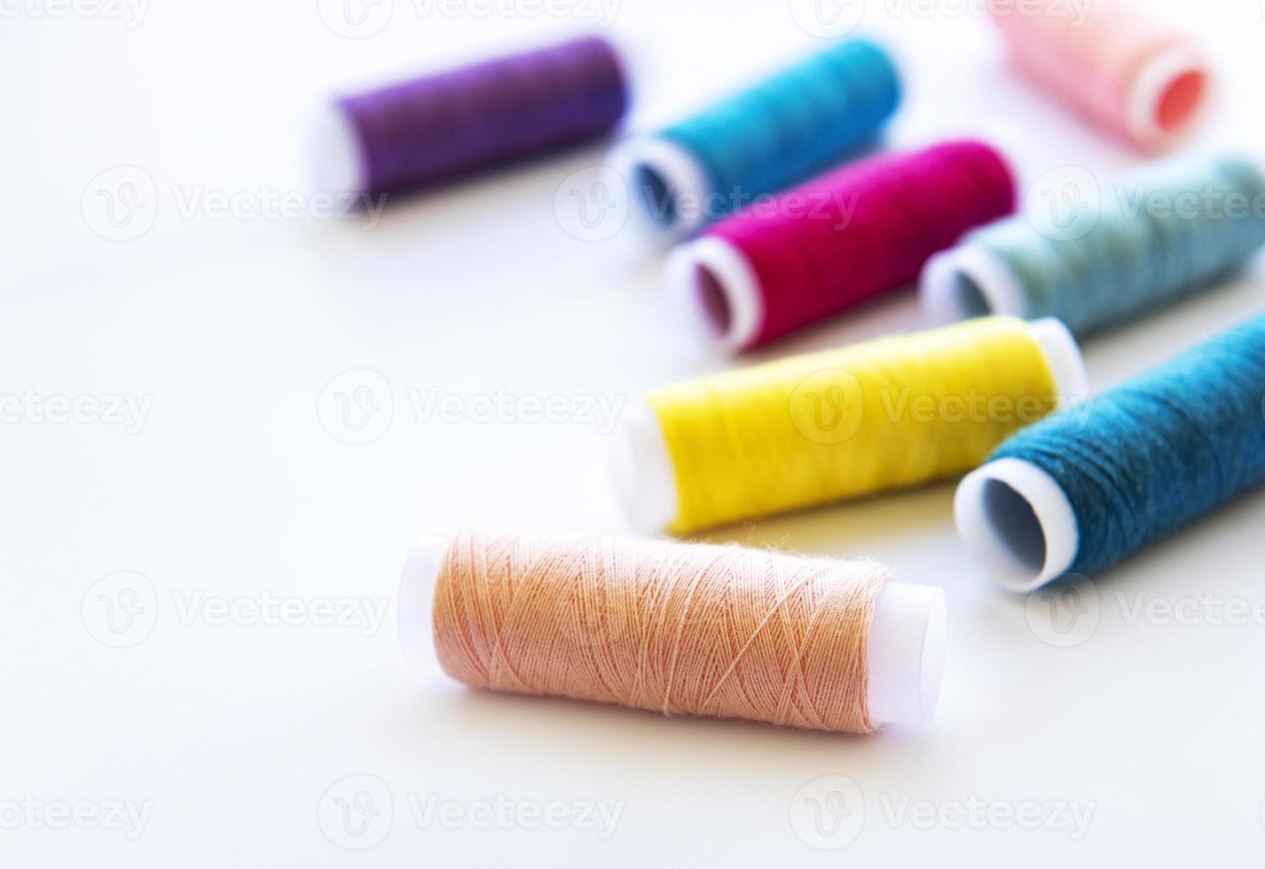 Spools of thread on a white photo