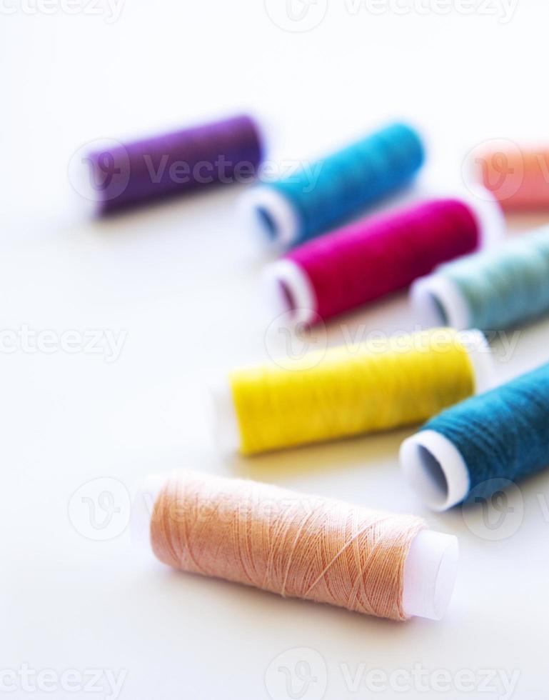 Spools of thread on a white photo