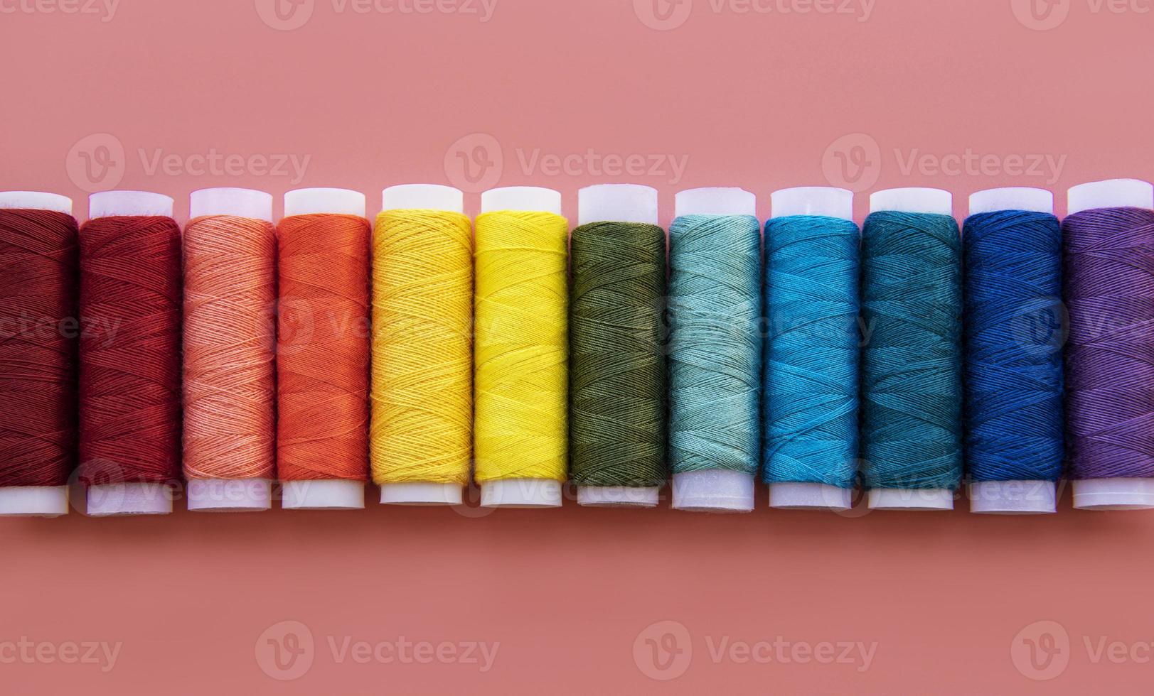 Spools of thread on the colors of the rainbow photo