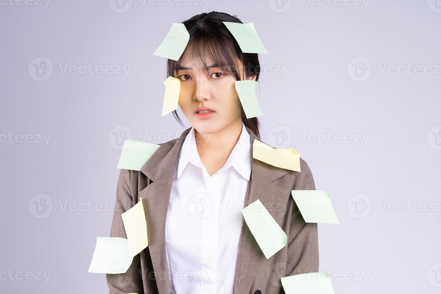 Young Asian businesswoman is feeling pressured by the deadline photo