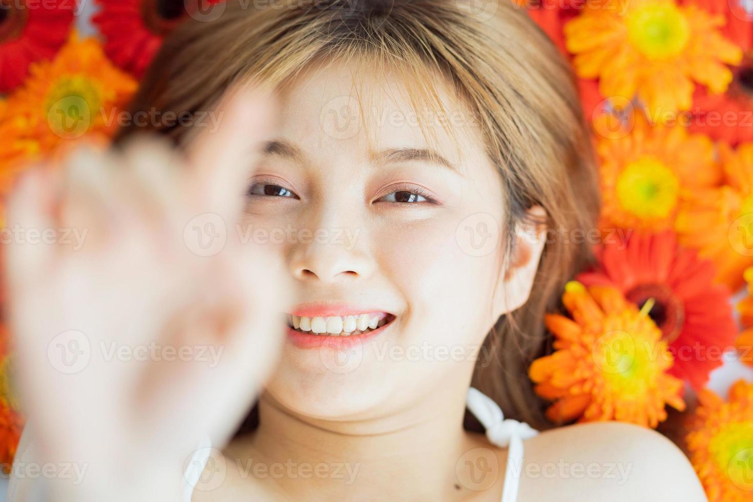 Young girl lying on a flower with a happy expression photo