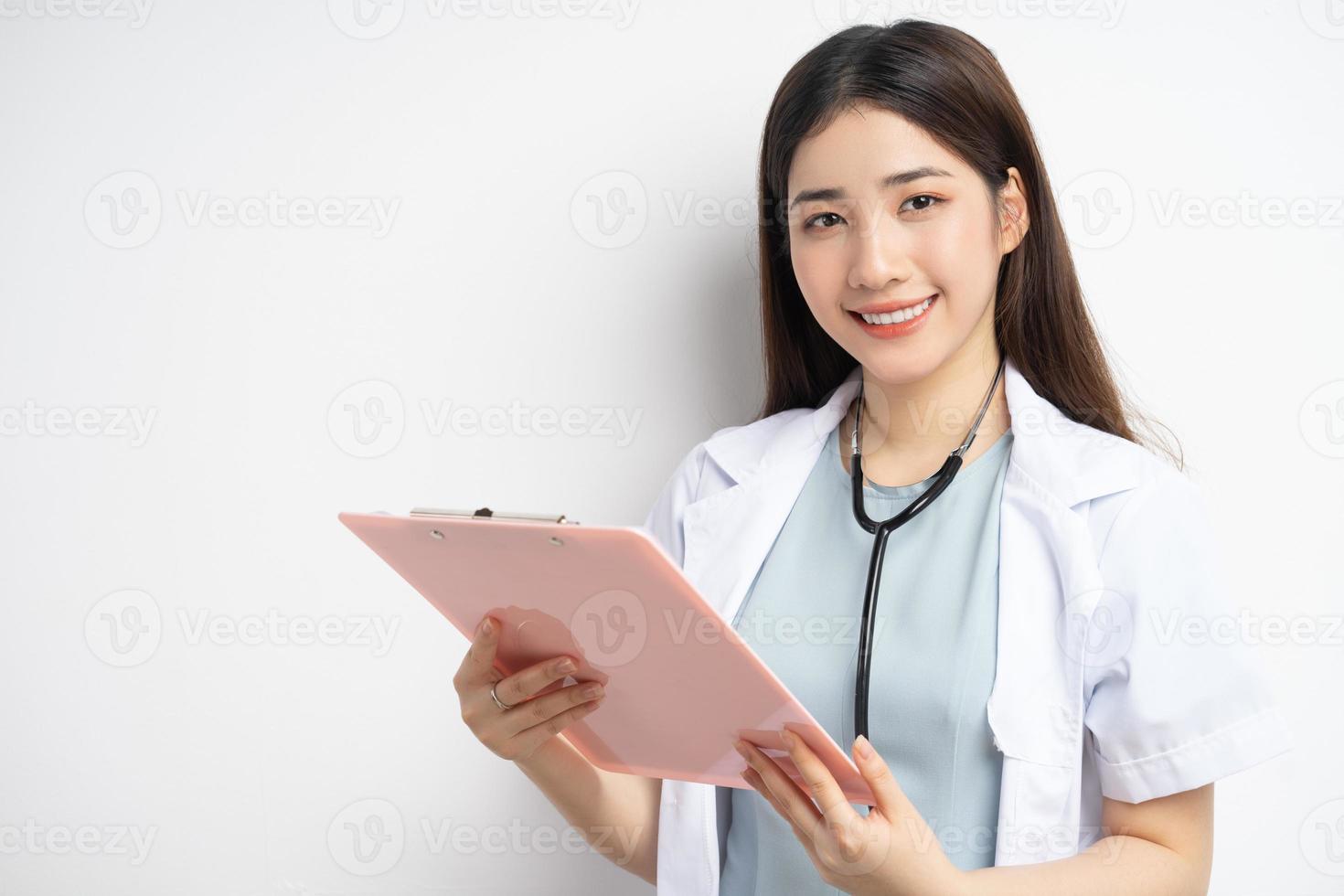 Portrait of female doctor holding document in hand photo