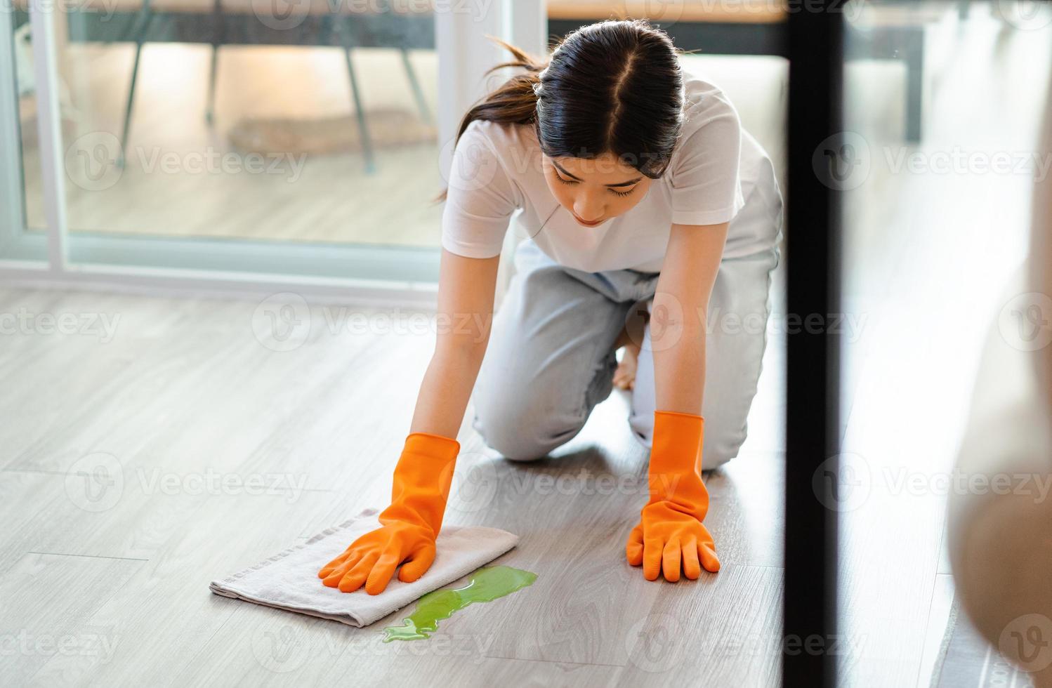 Beautiful Asian woman mopping the floor photo