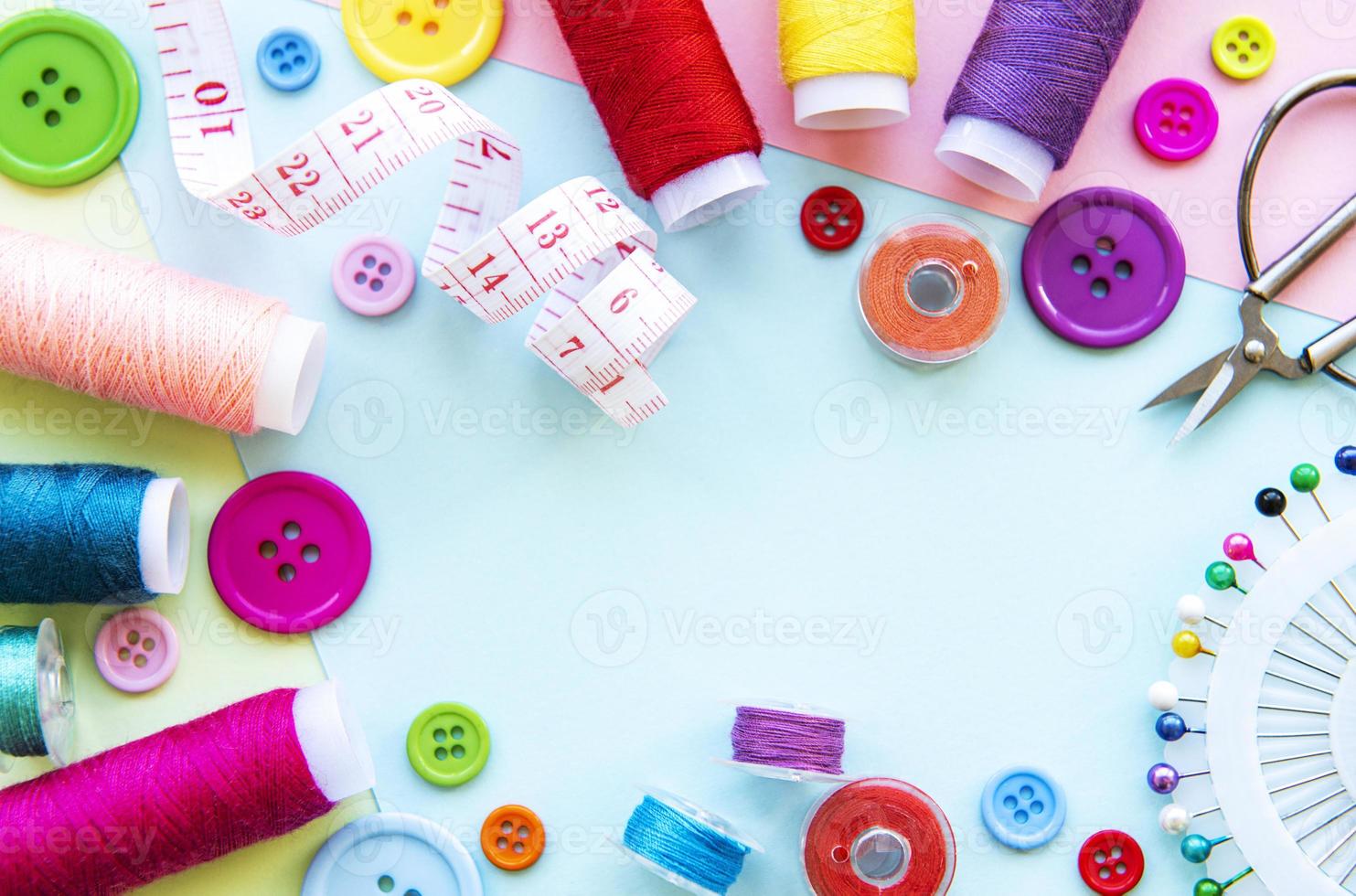Sewing accessories on a blue pastel background photo