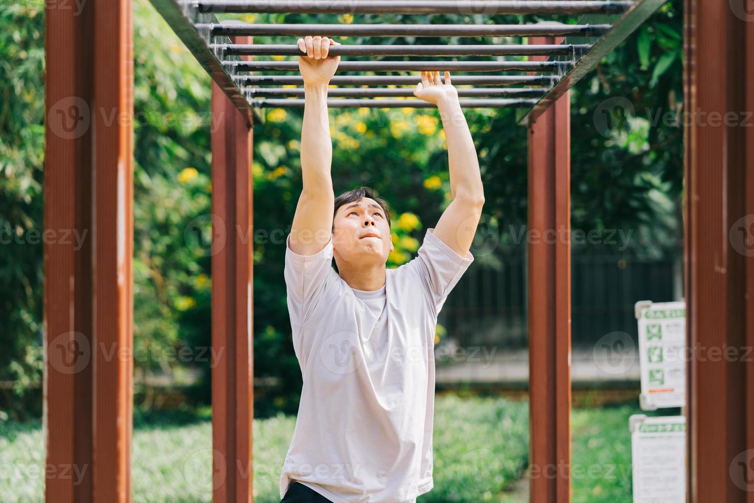 Asian man exercising in park photo