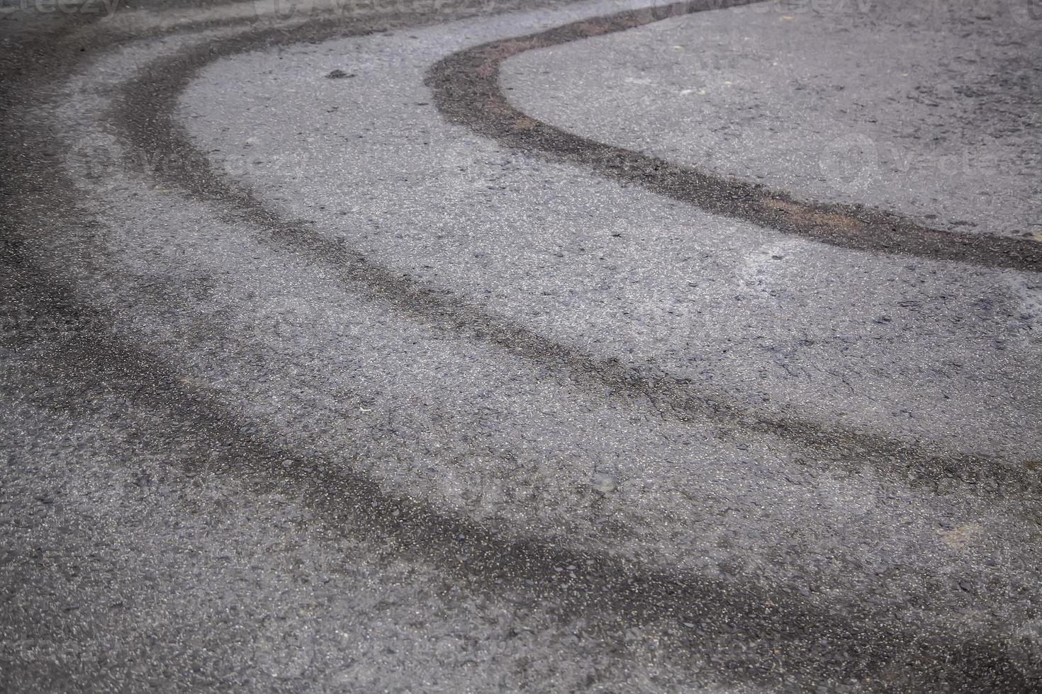 Wet wheel marks on the asphalt photo