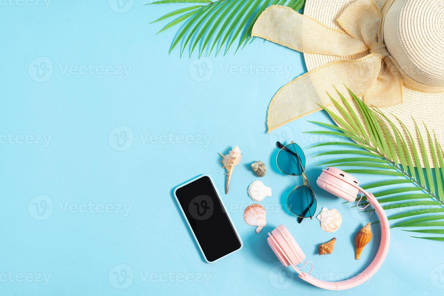 Top view photo of beach accessories on a blue background