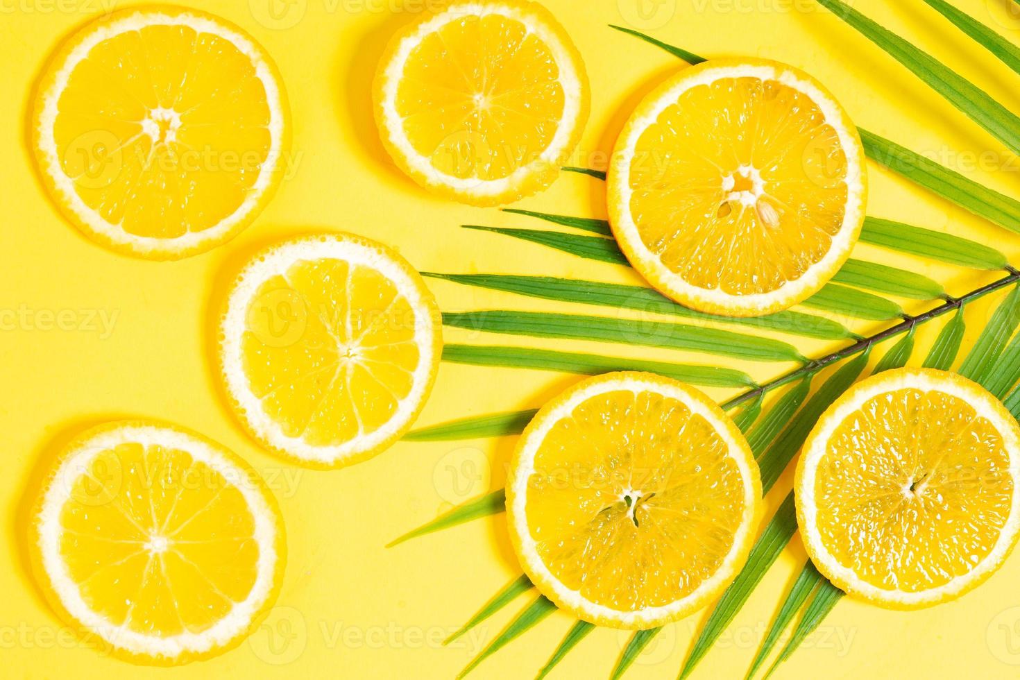 Orange slices placed on a yellow background photo
