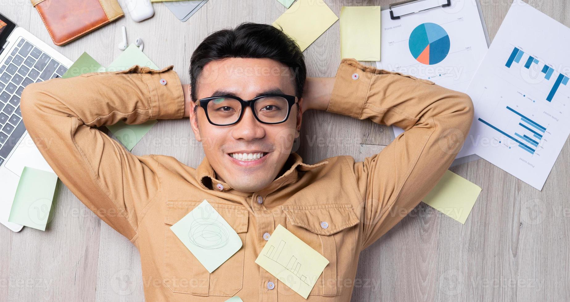 Asian man feels happy when he completes work on time photo