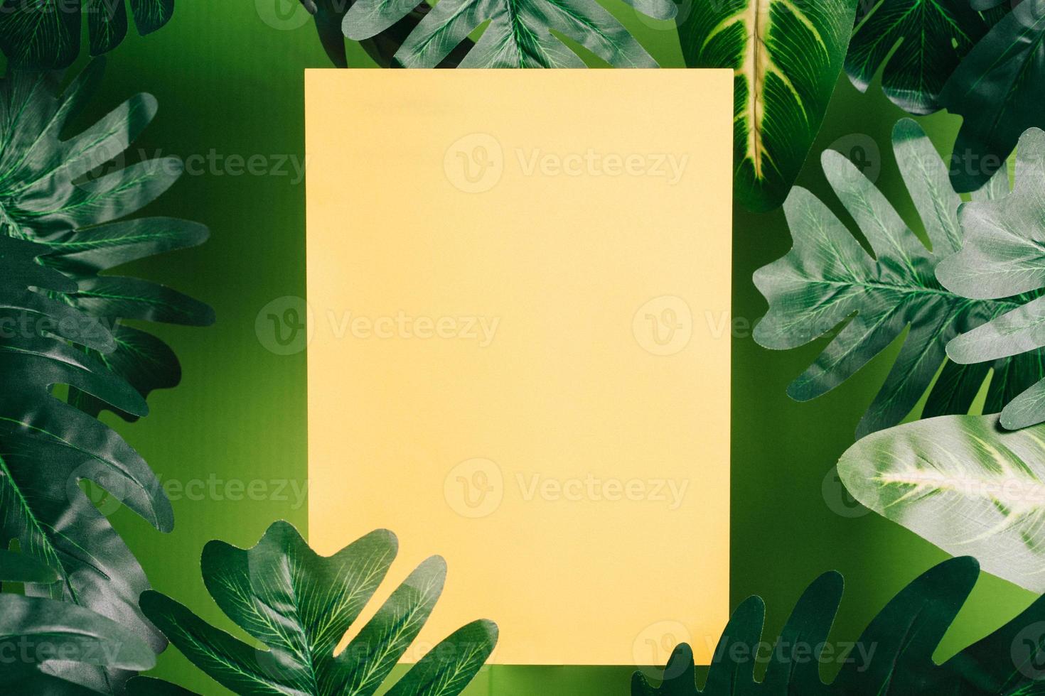 The yellow paper is placed among the leaves photo