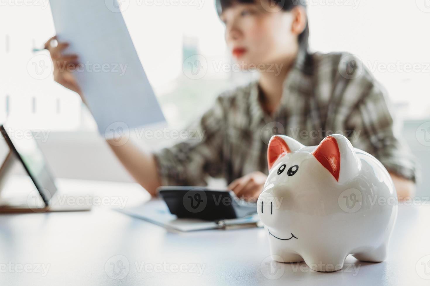 Young Asian woman is calculating the tax to pay photo