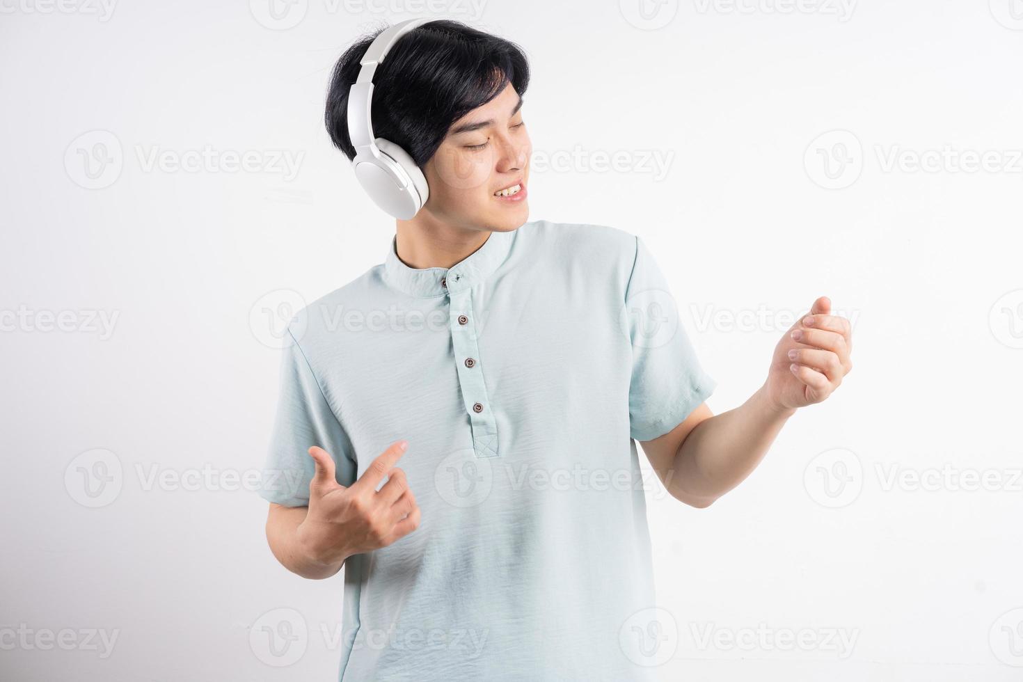 The Asian man was listening to music while singing along photo