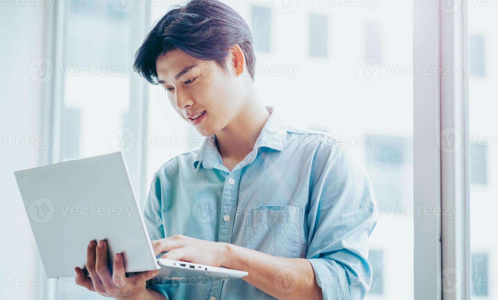 Portrait of an Asian male businessman working attentively photo