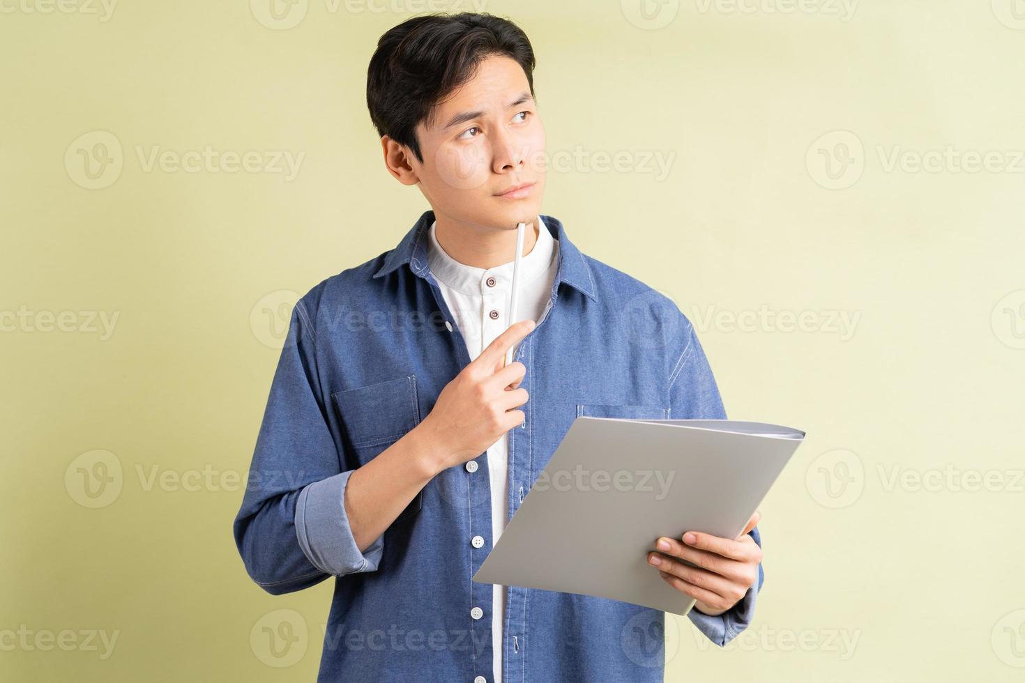 Photo of thinking handsome Asian businessman