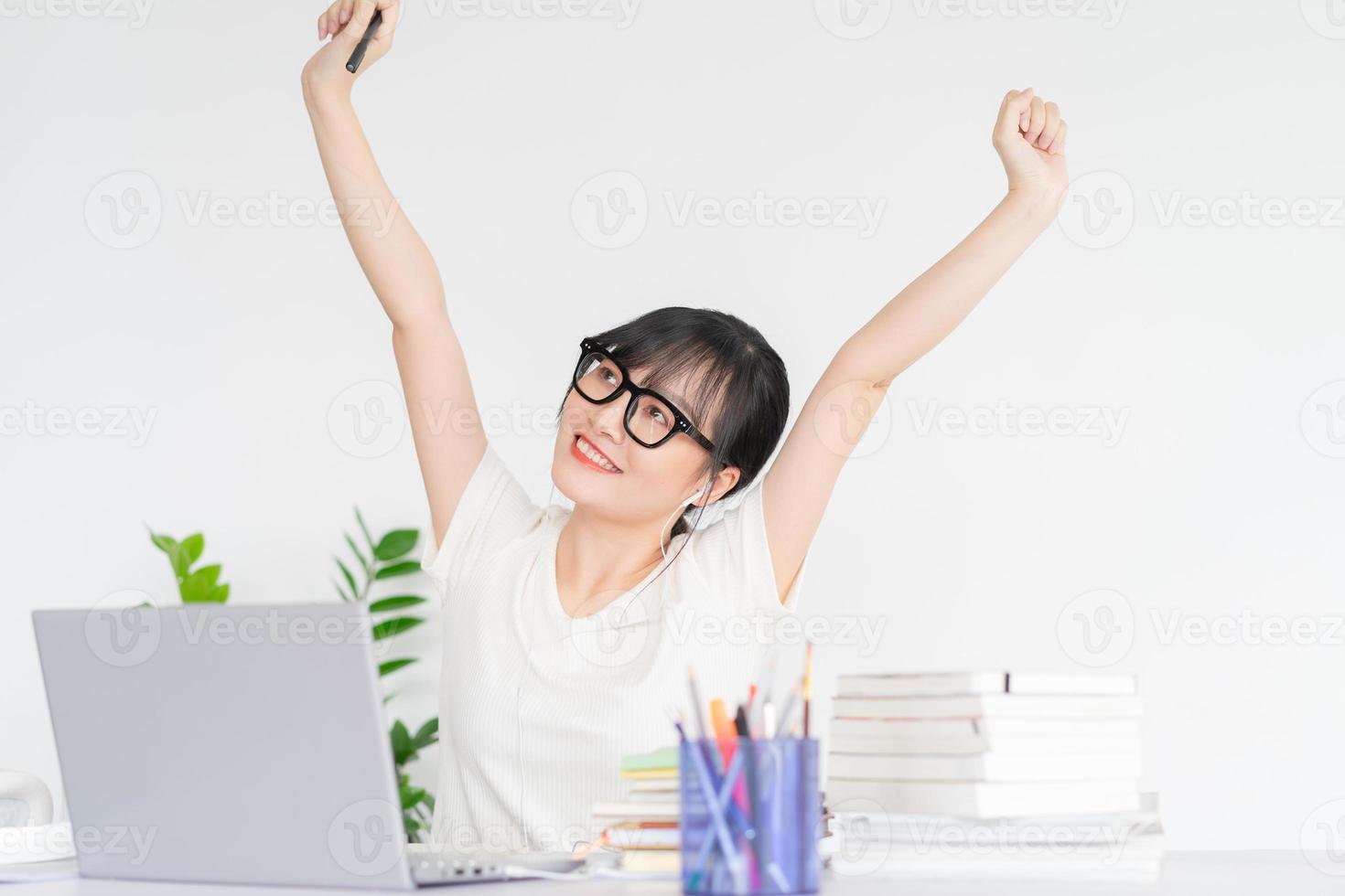 Asian businesswoman is stretching her shoulders after finishing her work photo