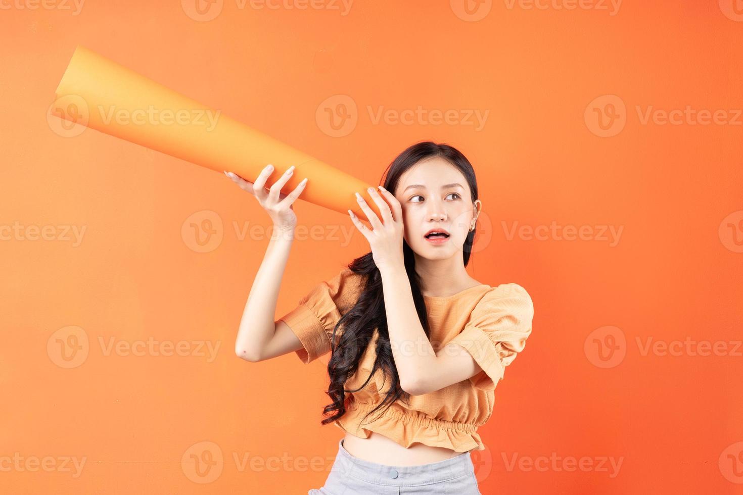 Asian woman using a paper speaker, Concept announces photo