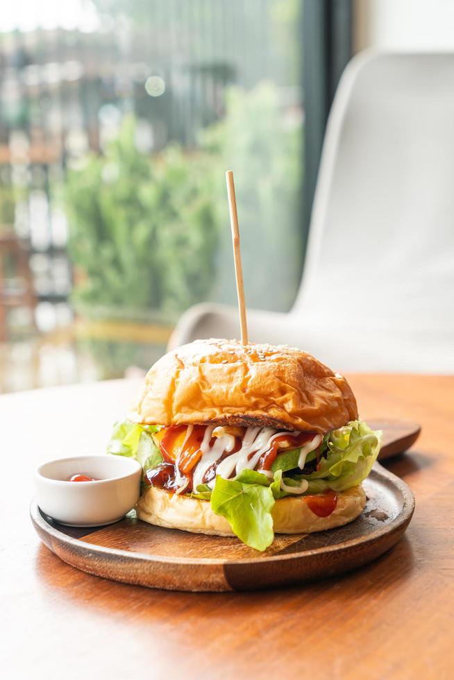 Beef burger with cheese and sauce on wood plate photo