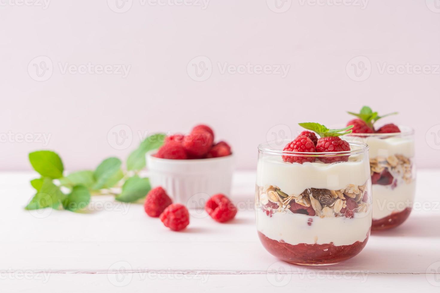 Fresh raspberry and yogurt with granola - Healthy food style photo