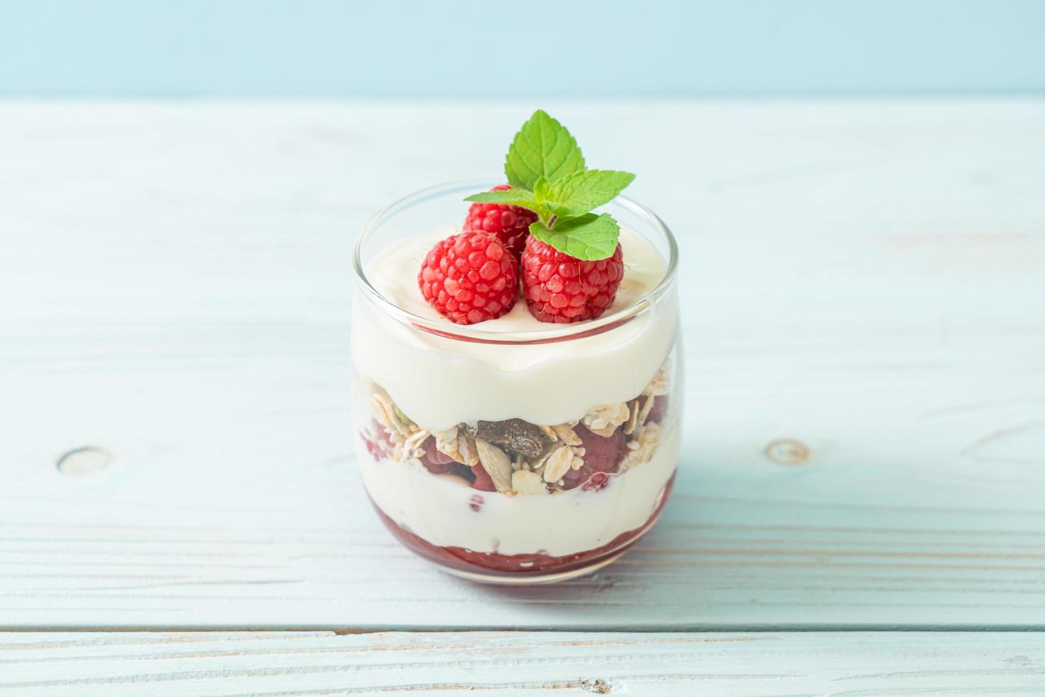 Fresh raspberry and yogurt with granola - Healthy food style photo