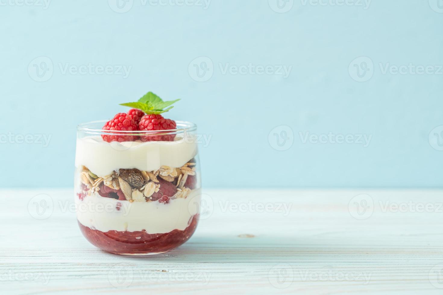 Fresh raspberry and yogurt with granola - Healthy food style photo