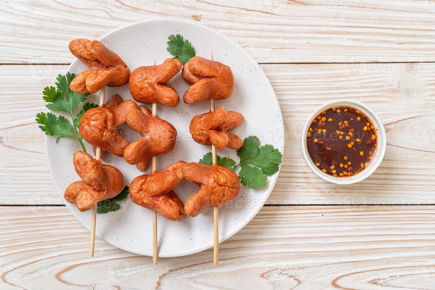 Deep fried sausage skewer with dipping sauce photo