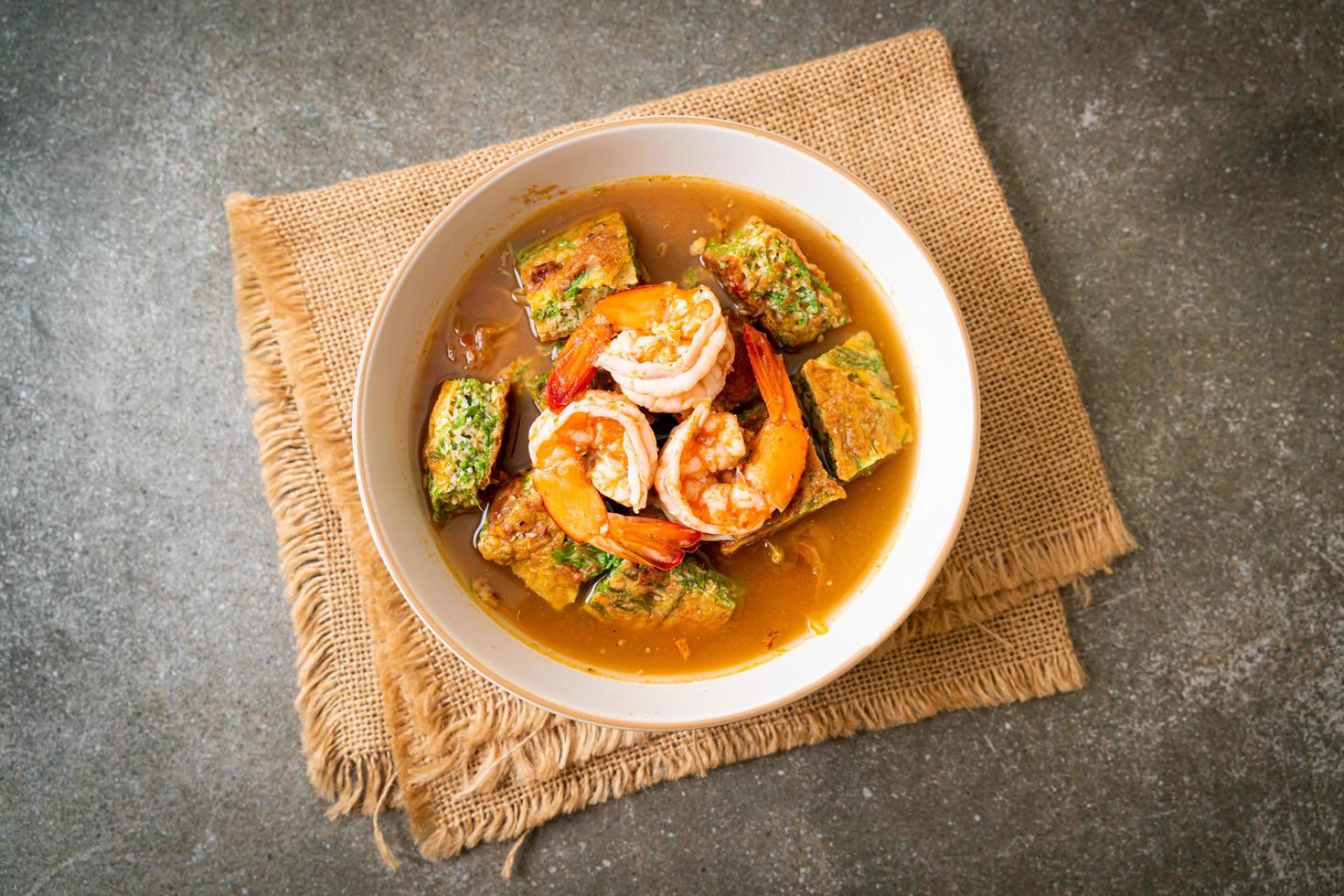 Sour soup made of Tamarind Paste with Shrimps and Vegetable Omelet photo