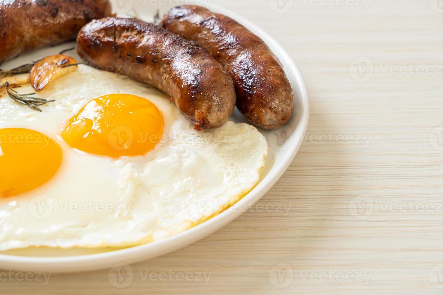 Homemade double fried egg with fried pork sausage - for breakfast photo