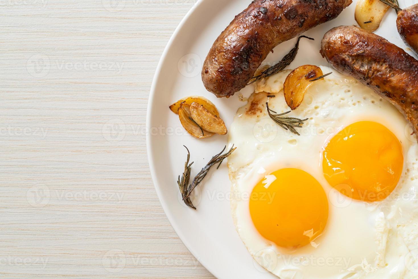 Homemade double fried egg with fried pork sausage - for breakfast photo