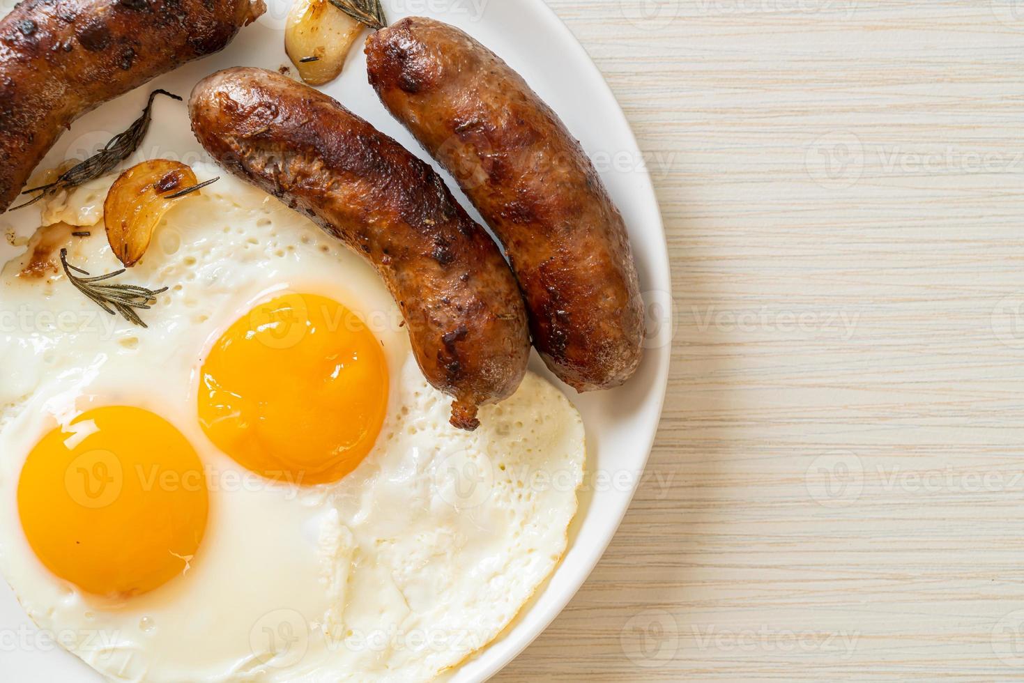 Homemade double fried egg with fried pork sausage - for breakfast photo