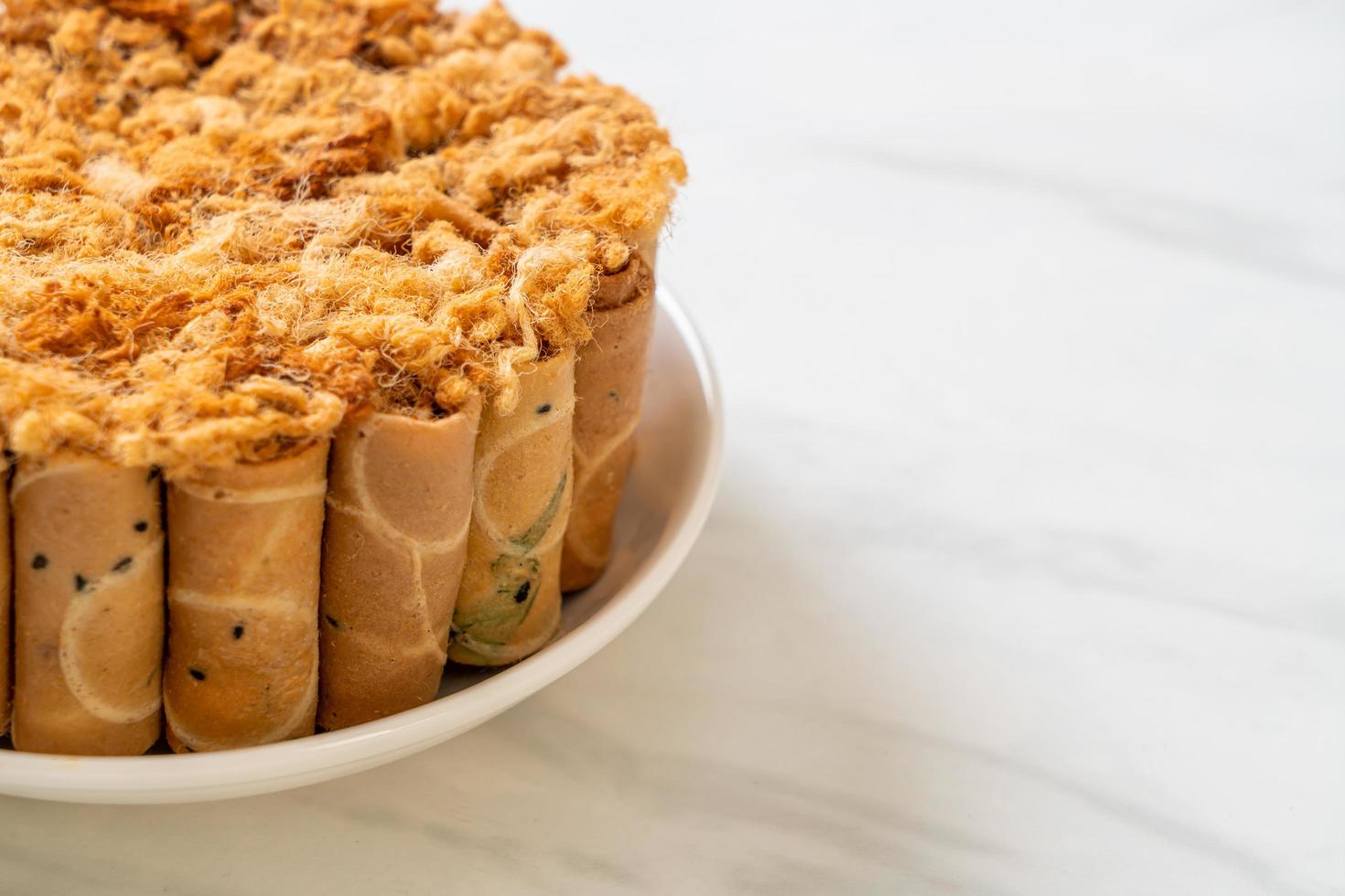 Crispy coconut roll with dried shredded pork on plate photo