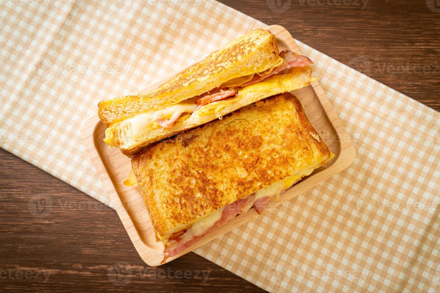 Homemade French toast with ham, bacon, and cheese sandwich with egg photo