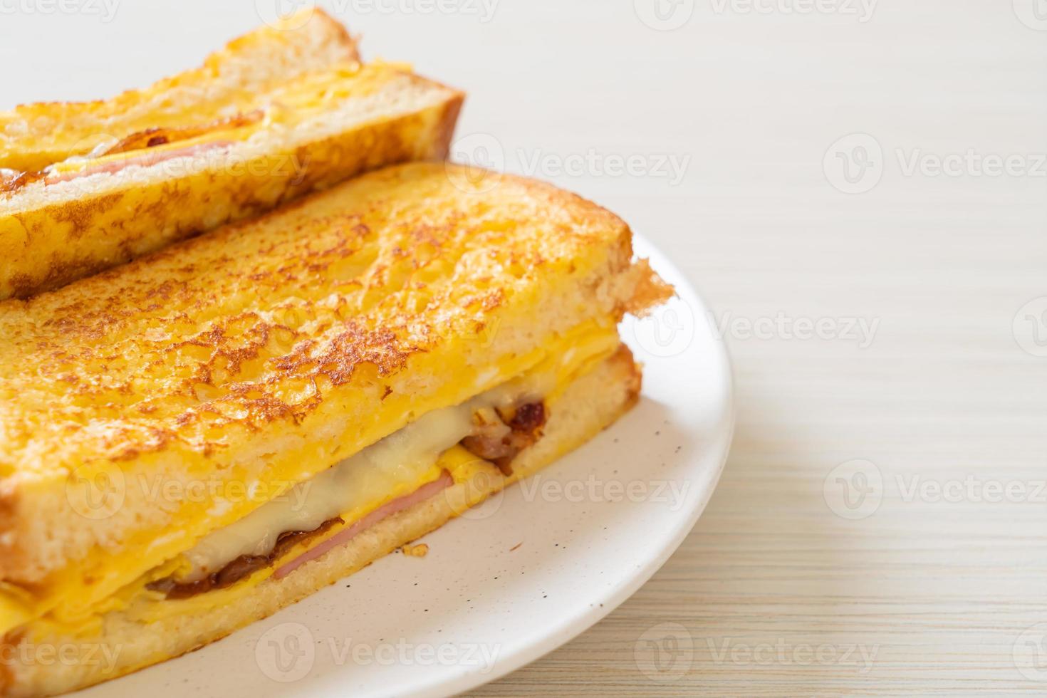 Homemade French toast with ham, bacon, and cheese sandwich with egg photo