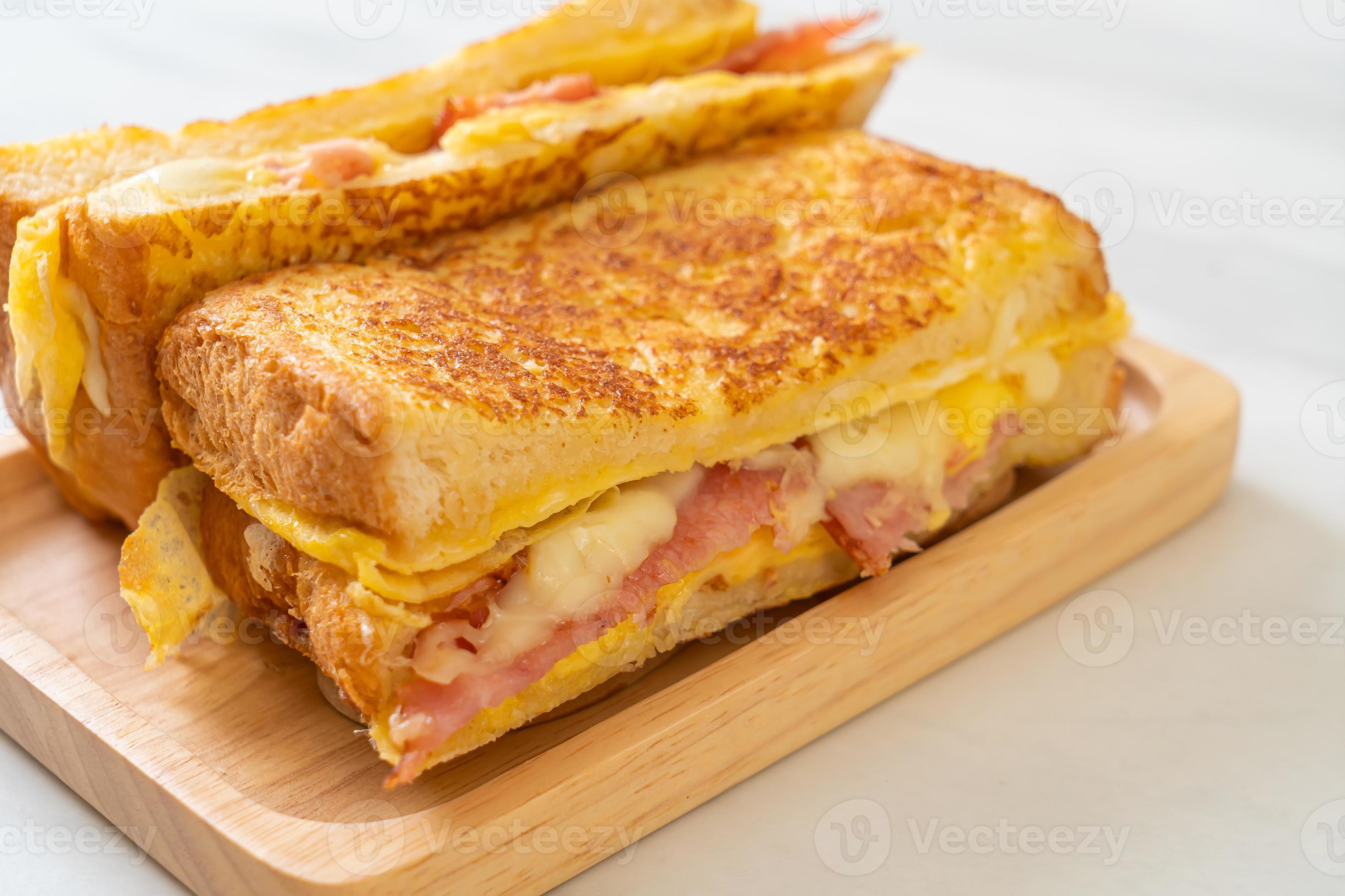 Homemade French toast with ham, bacon, and cheese sandwich with egg