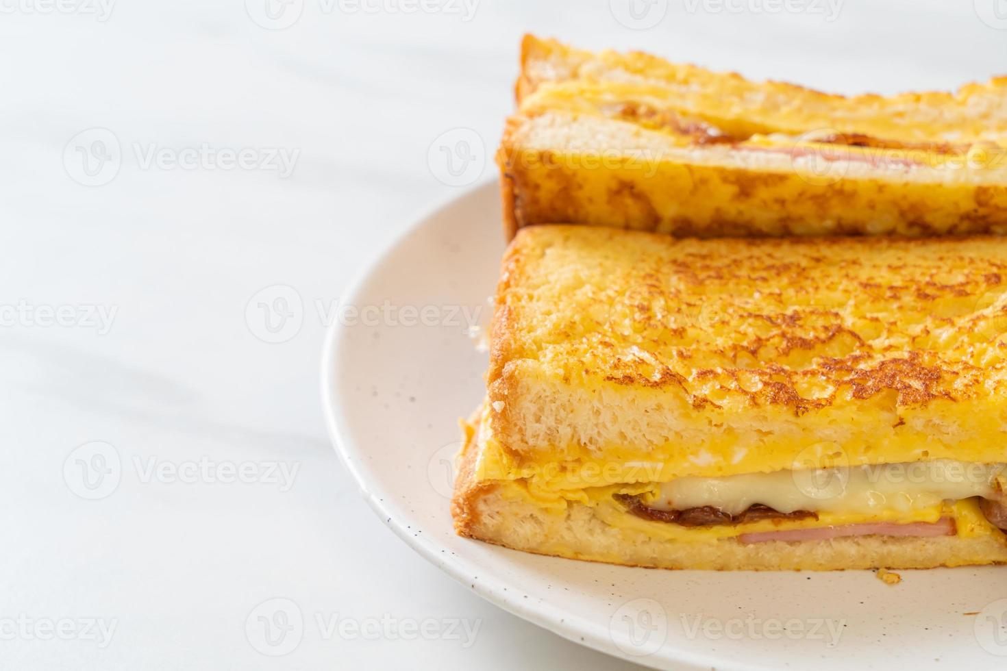 Homemade French toast with ham, bacon, and cheese sandwich with egg photo