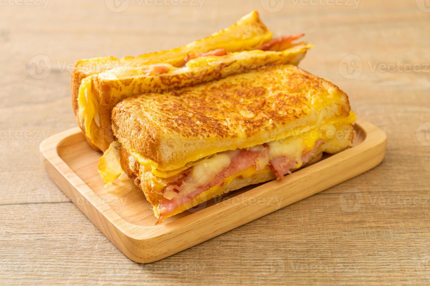 Homemade French toast with ham, bacon, and cheese sandwich with egg photo