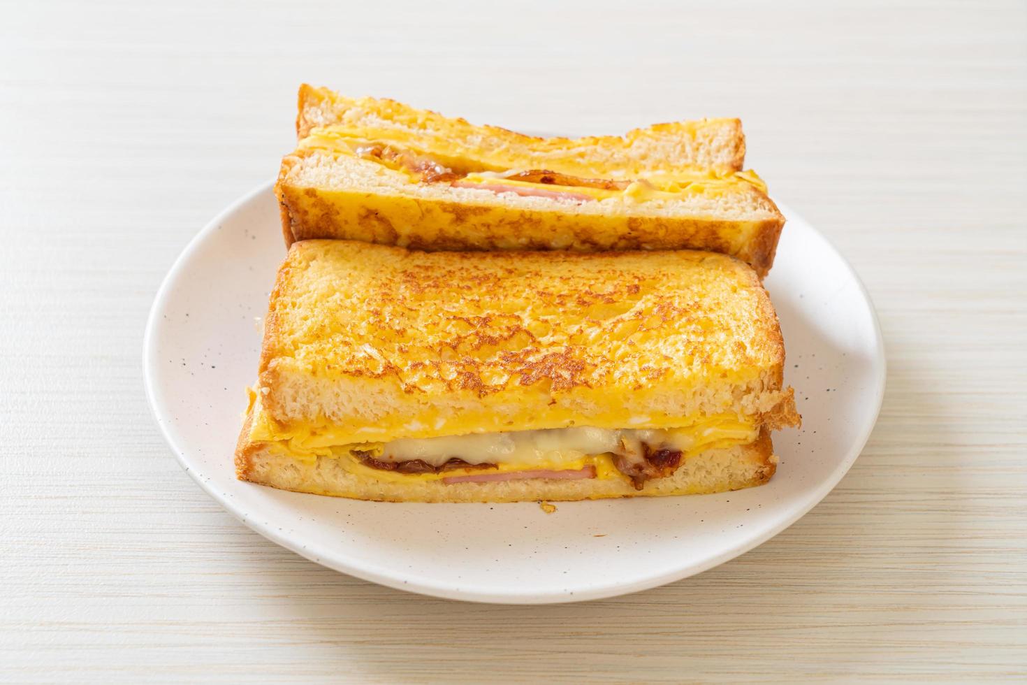 Homemade French toast with ham, bacon, and cheese sandwich with egg photo