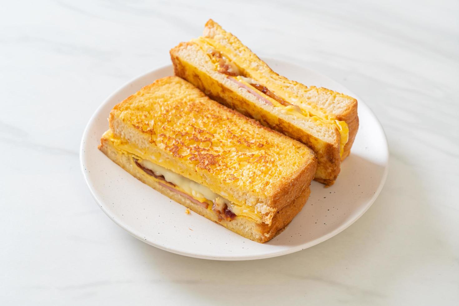 Homemade French toast with ham, bacon, and cheese sandwich with egg photo