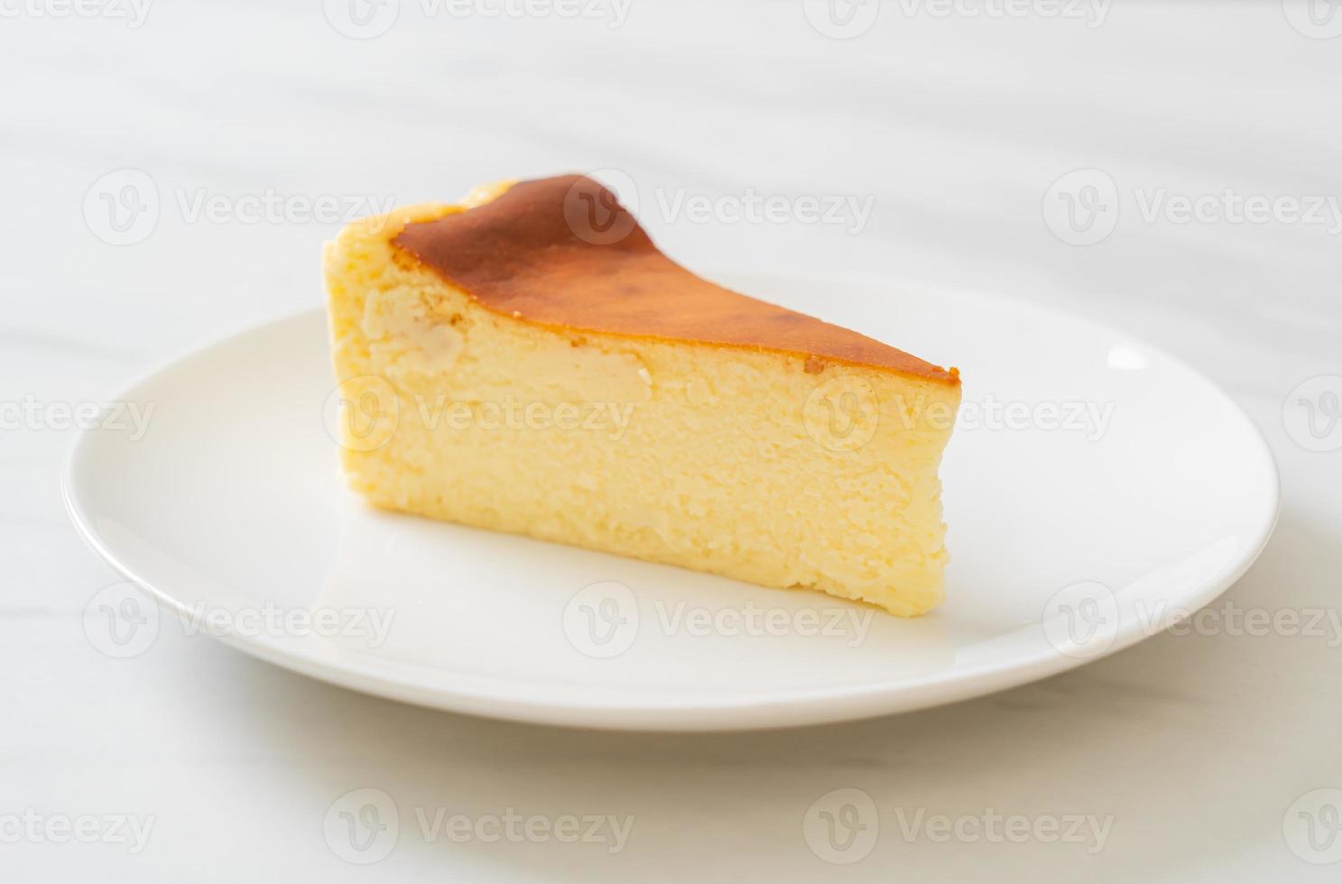 Homemade burn cheesecake on a white plate photo