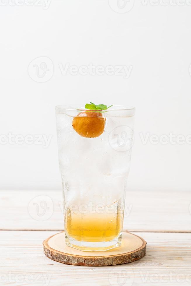 Iced plum juice with soda and peppermint on the wood table - refreshment drink photo